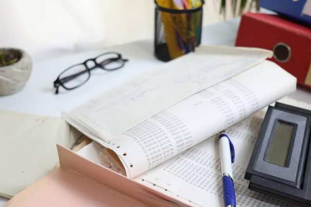 Calculator on a desk beside financial notes