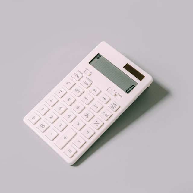 White calculator on a pale desk