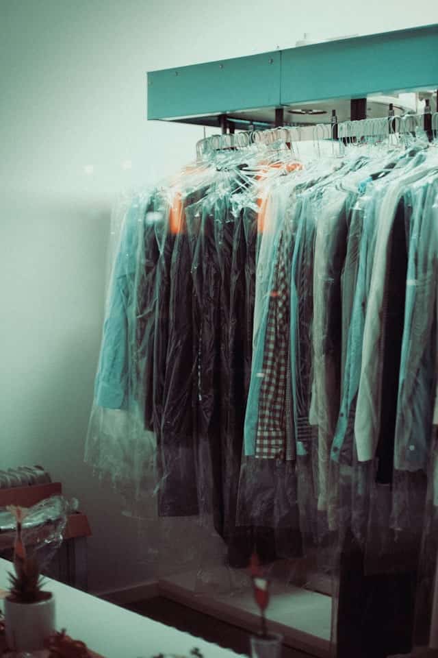 Clothes hanging in clear dry-cleaning bags
