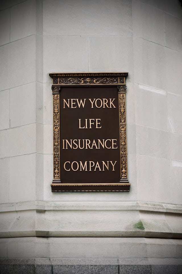 Historic New York Life Insurance Company sign on a stone wall