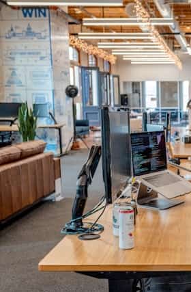 Empty office workspace with desks and monitors
