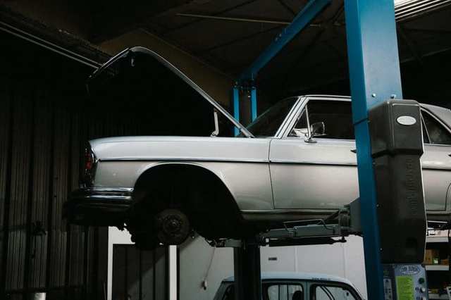 Car raised on a lift in a garage