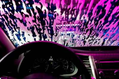 Car dashboard and windscreen covered with wash suds