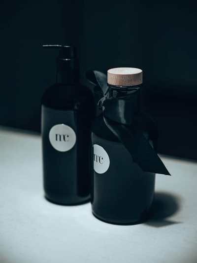 Bright nail polish bottle among colourful manicure tools