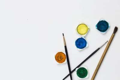 Colourful paint pots and decorating brushes