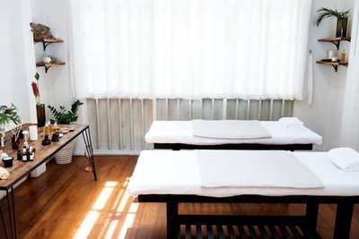 Bright therapy treatment room with padded tables