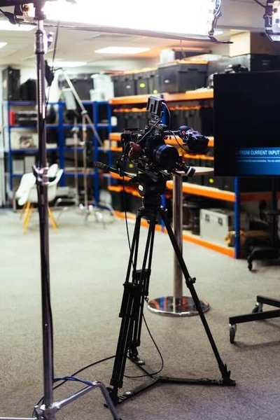 Camera on a tripod in a studio