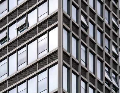 Reflective glass facade with rows of modern windows